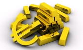 Koncept zlatých cihel spolu se zlatým symbolem eura